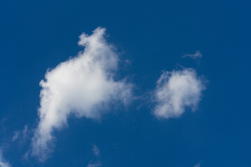 Fototapeta na wymiar Cluster of clouds on deep blue sky background