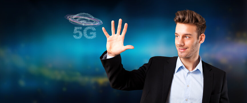 businessman with message 5G on abstract blue background