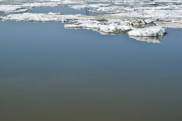 Ice over the smooth surface of the water.