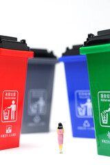 color trash can trash sorting with a woman standing 