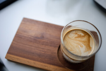 cup of hot coffee on wooden plate