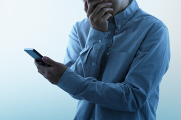 Victim of internet fraud and bullying. Man seeing smartphone with shocked look.