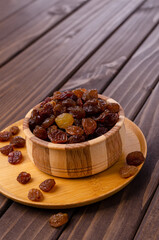 Dark raisins in a wooden dish