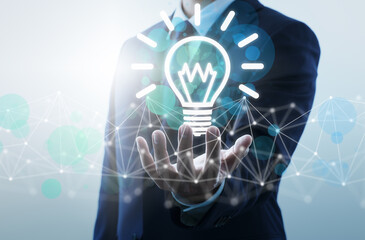 Business ideas and network technology. Businessperson holding lightbulb icon.