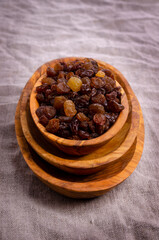 Dark raisins in a wooden dish