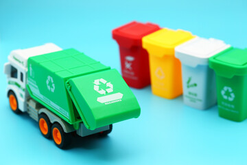 Garbage removal truck and garbage sorting bins on blue background