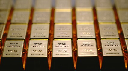 Many gold bars in a bank vault