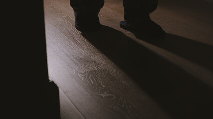 Senior walks in slippers in a the night at home