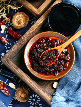 A wooden spoon to scoop up a spoonful of Sichuan chili sauce