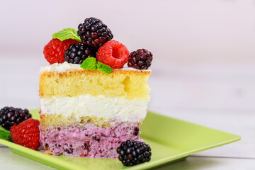 Piece of sweet cake with fresh berries on the top.