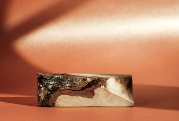 Wood podium on pink background with sunlight shadows for cosmetic product presentation.Empty showcase pedestal backdrop mock up.