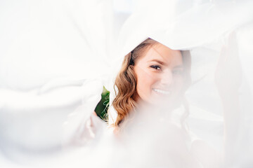 beautiful bride with long curls under the veil. delicate female portrait.