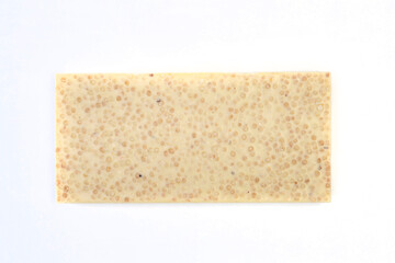 sweet and delicious whole chocolate bar is lying on white background, photo taken from above