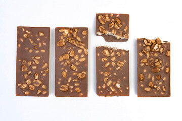 sweet and delicious whole chocolate bar is lying on white background, photo taken from above