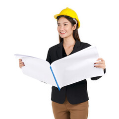 Young businesswoman in black suit, wearing a yellow construction helmet, unfolds the construction plan, looking out in the distance.