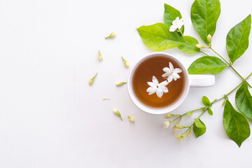 Jasmine tea with flowers jasmine in white cup on white wooden. hot tea from nature for health....