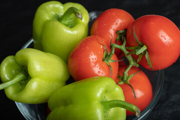 Close up photo of o fresh organic vegetables. ripe tomatoes and peppers in bowl