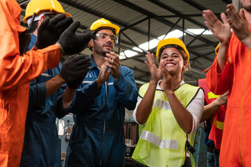 Skillful worker celebrate success in the factory . Industrial people and manufacturing labor...