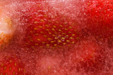 .Frozen strawberries covered by frost, berry Victoria, close-up. Berry in ice