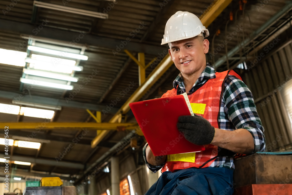 Poster manufacturing worker working with clipboard to do job procedure checklist . factory production line 