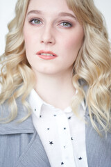 Naklejka premium Portrait of beautiful serious blonde business woman on white background