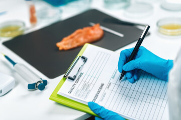 Food Safety and Quality Management. Inspector Filling Out Quality Control Form in a Laboratory