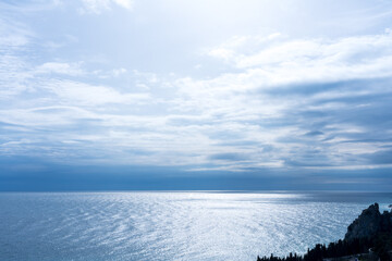 Silver blue colors of the sea and sky on a spring cloudy day
