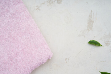 Towel on white background with fresh petals