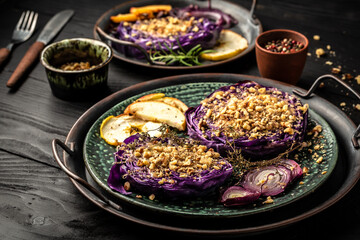 Autumn dish of red cabbage baked with nuts, quince and apples, Vegan roasted red cabbage steaks, Food recipe background. Close up