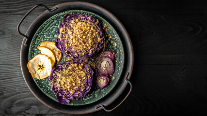 Autumn dish of red cabbage baked with nuts, quince and apples, Vegan roasted red cabbage steaks, Food recipe background. Close up