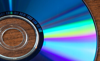 The CD disc shimmers with a rainbow color.
