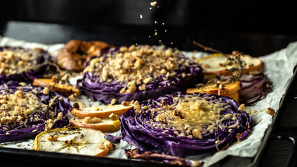 Traditional German dish of red cabbage baked with nuts, quince and apples, chef cooking autumn dish...