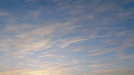 Naklejka na ściany i meble Cloudscape at sunset against the blue sky