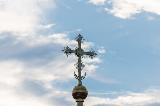A golden cross on the dome of an Orthodox Christian church