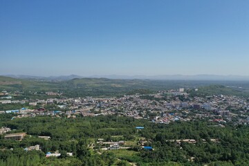Fototapeta na wymiar Aerial photography of beautiful city. Green hills and houses crisscross the city