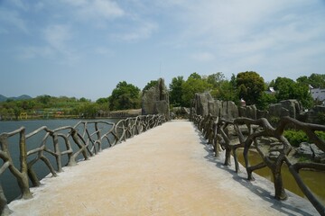 Fototapeta premium Concrete walkway above a park lake