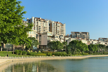 Buildings on the waterfront in sunny weather with blue background