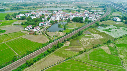 Fototapeta na wymiar Aerial view of green fields and rural roads; beautiful Chinese rural scenery