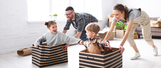 Optimistic family having fun during relocation in new flat