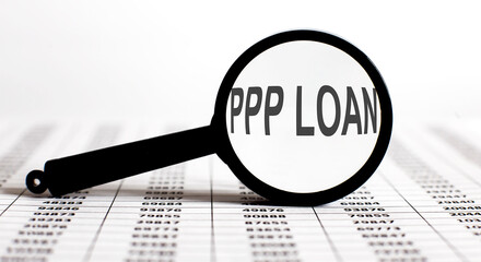 Magnifier with text PPP LOAN on the chart background