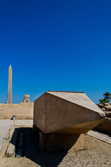 KARNAK TEMPLE - Massive columns inside beautiful Egyptian landmark with hieroglyphics, and ancient symbols. Famous landmark in the world near the Nile River and Luxor, Egypt