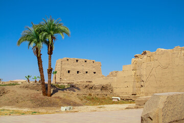 KARNAK TEMPLE - Massive columns inside beautiful Egyptian landmark with hieroglyphics, and ancient symbols. Famous landmark in the world near the Nile River and Luxor, Egypt
