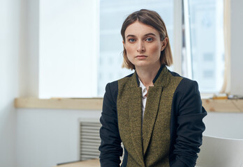 Portrait of a business woman in a suit In a bright room near the window