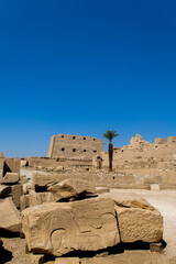 KARNAK TEMPLE - Massive columns inside beautiful Egyptian landmark with hieroglyphics, and ancient symbols. Famous landmark in the world near the Nile River and Luxor, Egypt