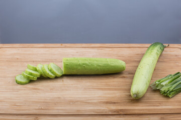 Cucumber slices on cutting board side view.