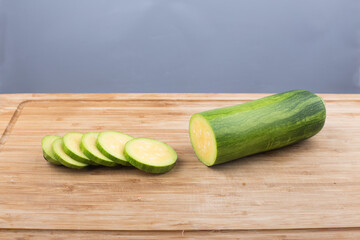 Courgette or Zucchini on wooden cutting board.