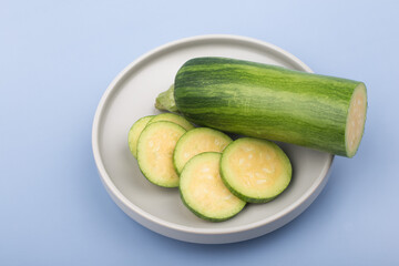 Courgette or Zucchini on wooden cutting board.