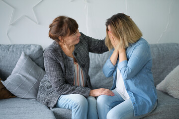 elderly mother hug crying adult daughter show support and care , supportive senior woman embrace cuddle grownup child feeling depressed, having life problems