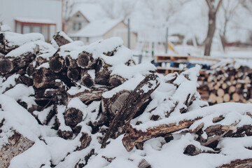 A pile of fire wood in North Texas covered in snow 