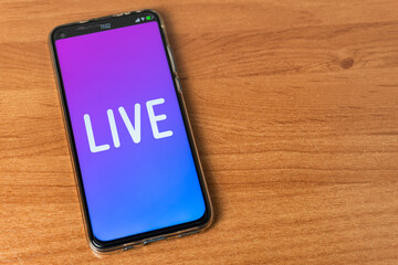 Phone with Live stream logo on table